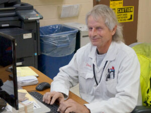 smiling man working on computer